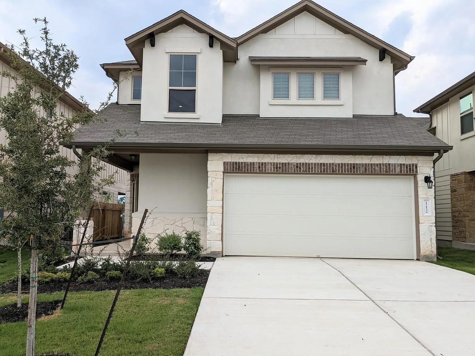 A well-maintained facade features stucco, brick, 