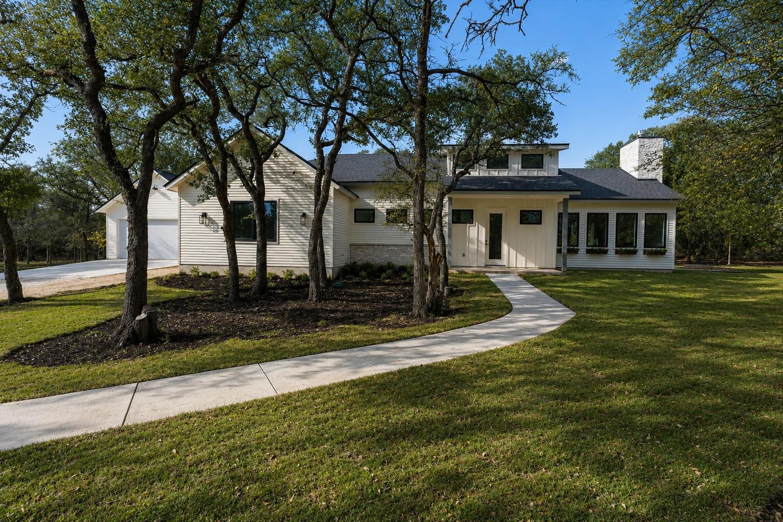 A graceful curved walkway leads to a contemporary
