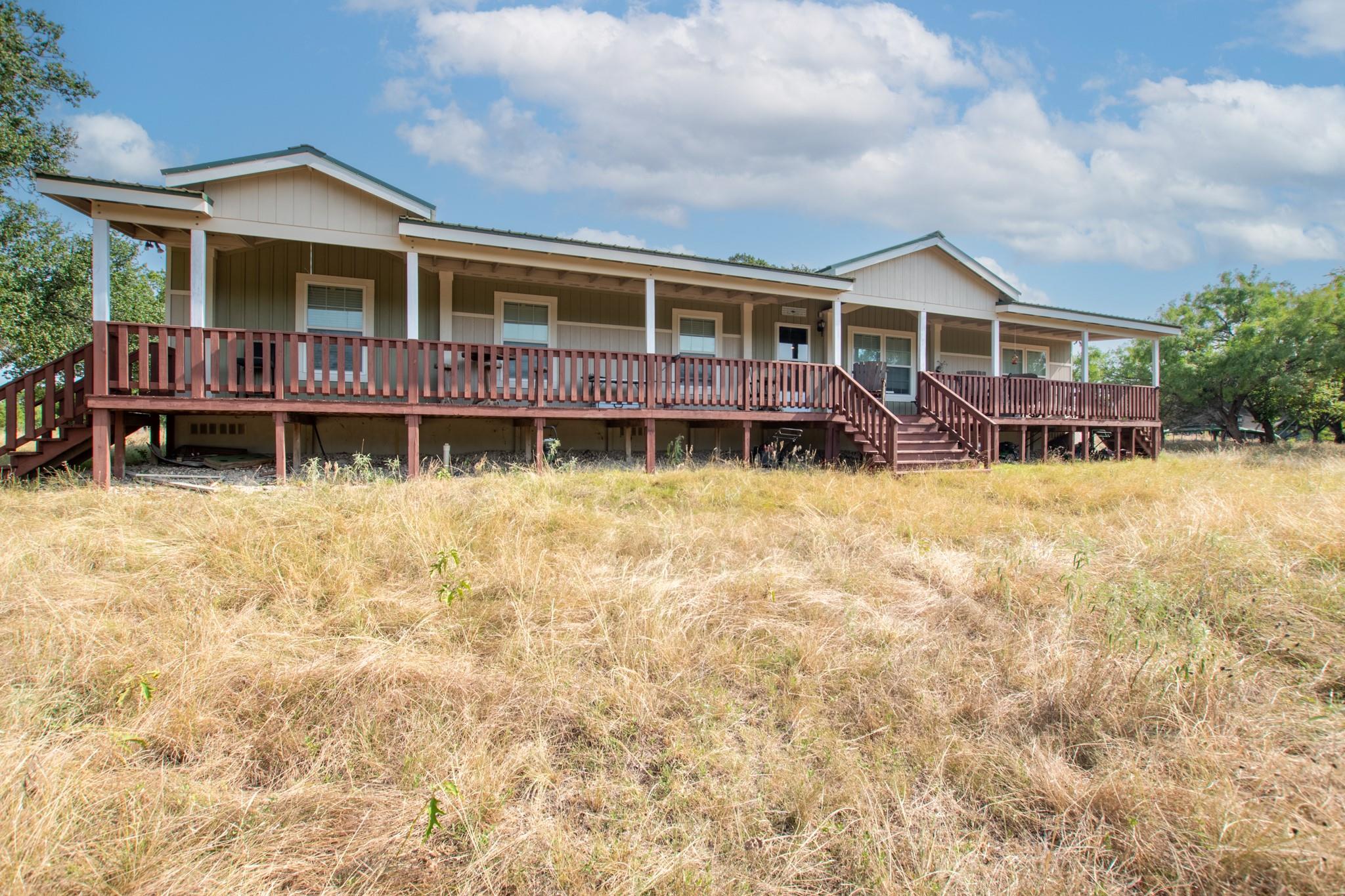 A country retreat awaits with a broad covered por