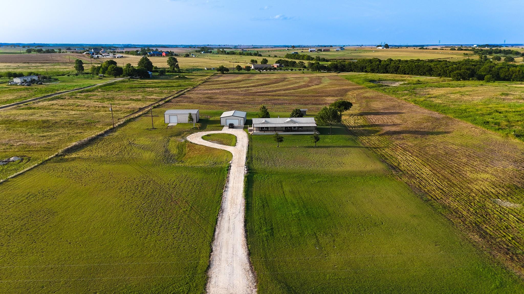 A winding driveway leads to a private residence, 
