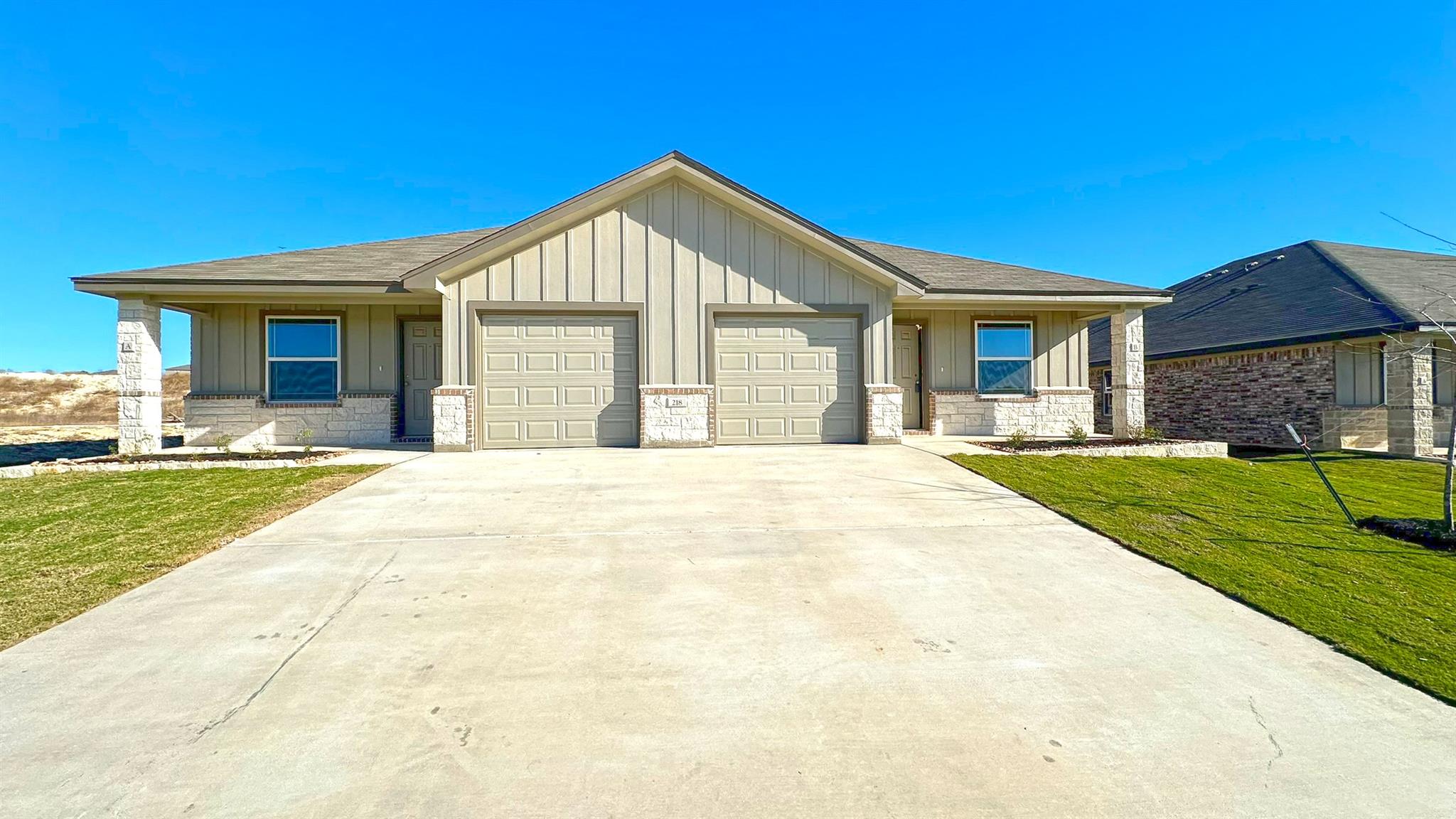 A contemporary duplex features a blend of vertica