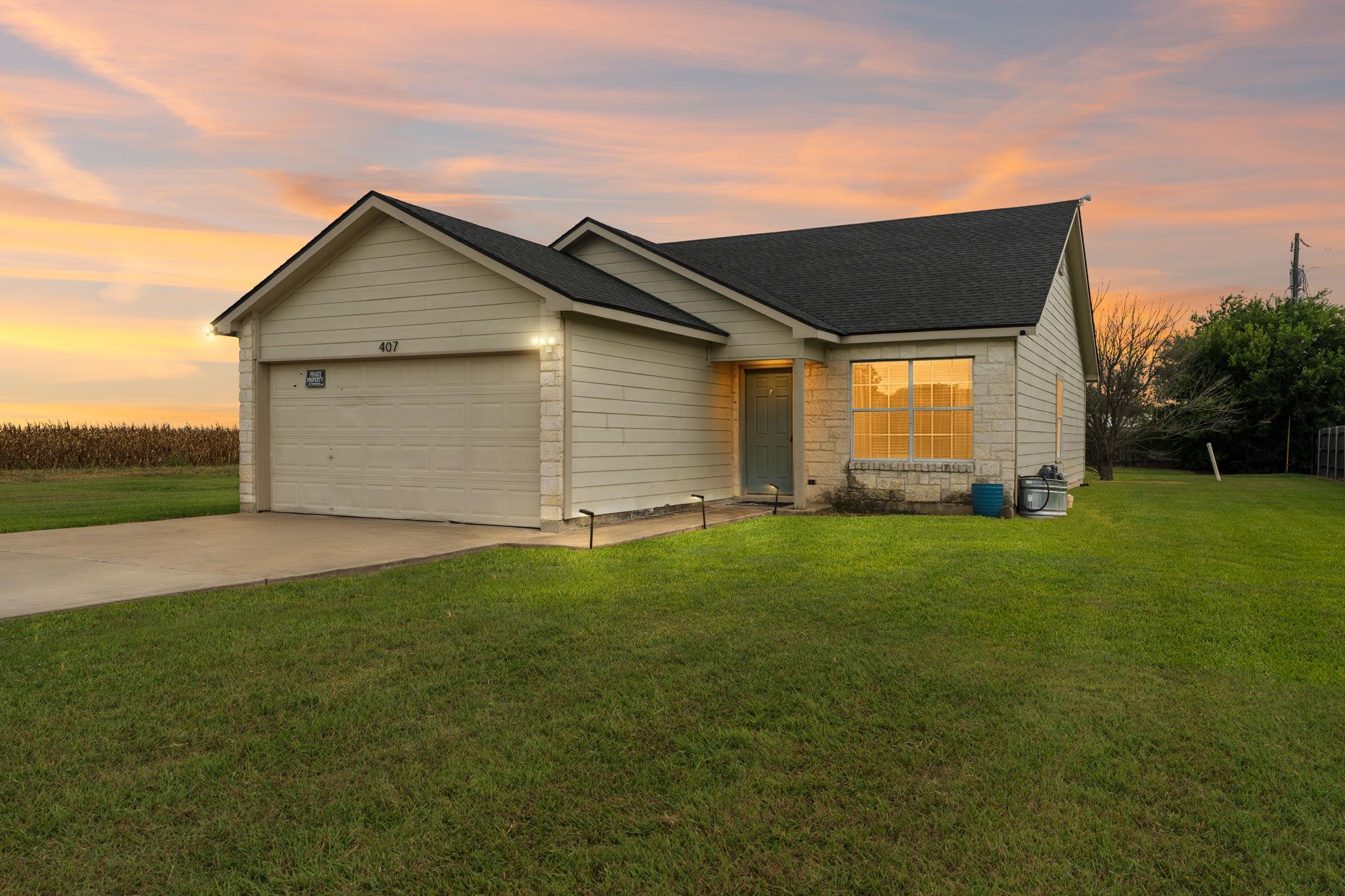 A modest single-story residence with a tidy lawn 