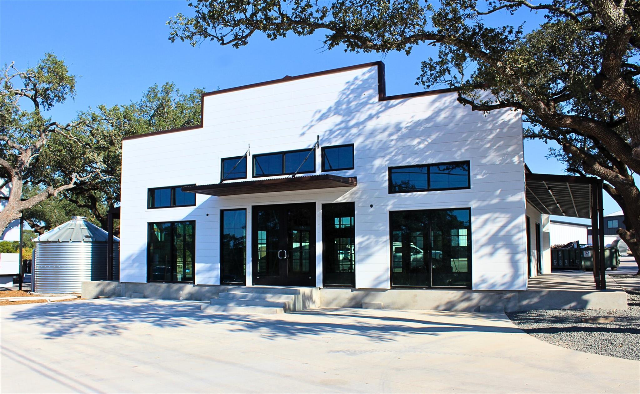 A modern facade with expansive glass doors and an