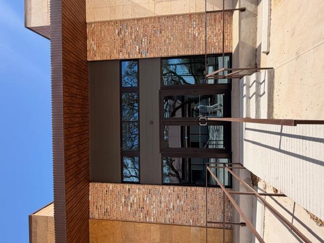 A striking modern building entrance blends textur