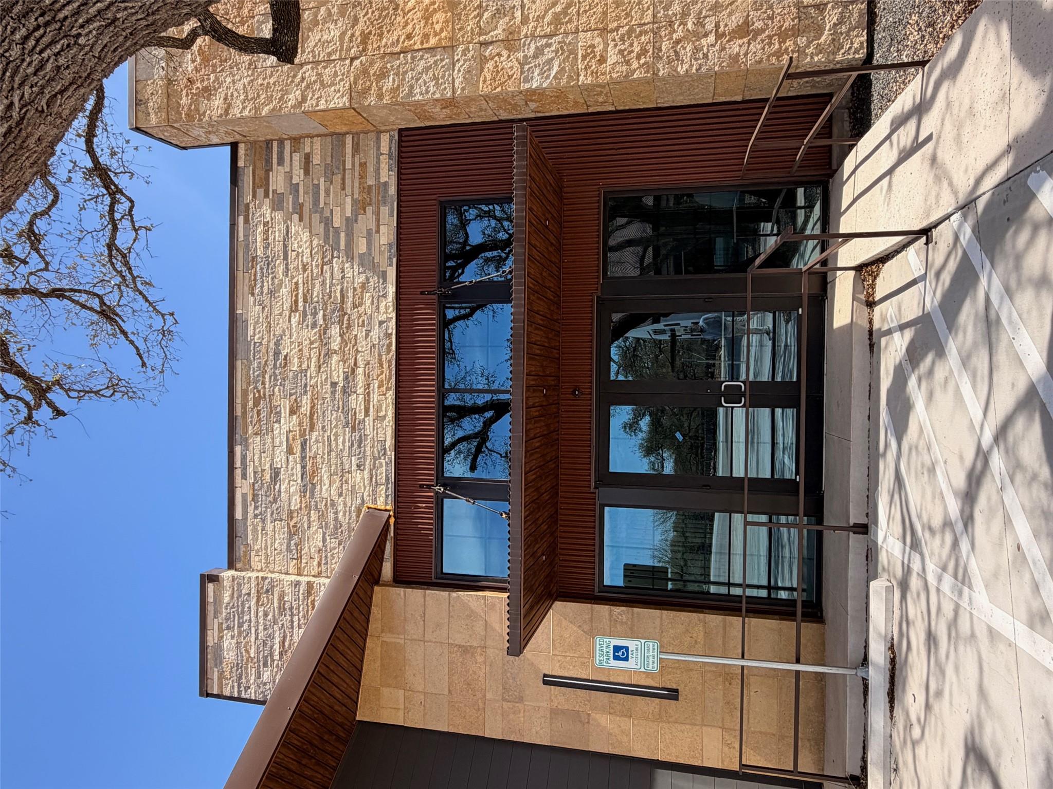 A striking exterior combines rich wood accents wi