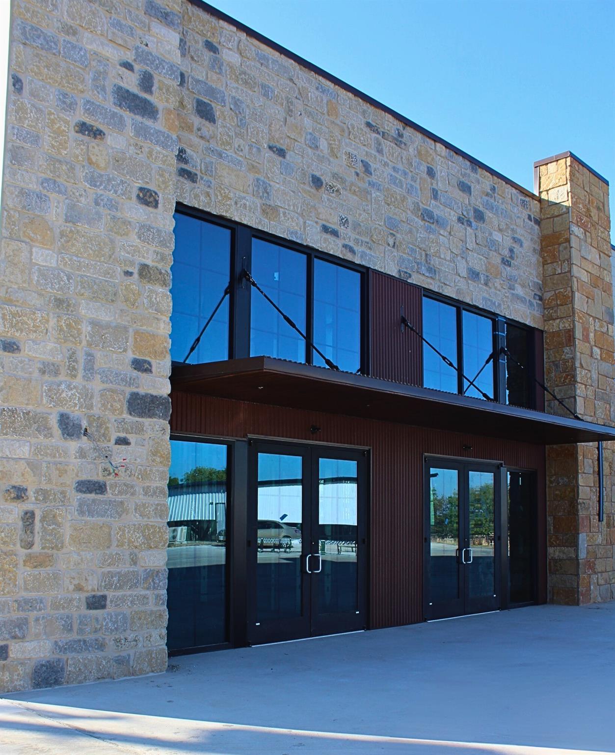 A commercial facade features natural stone and a 