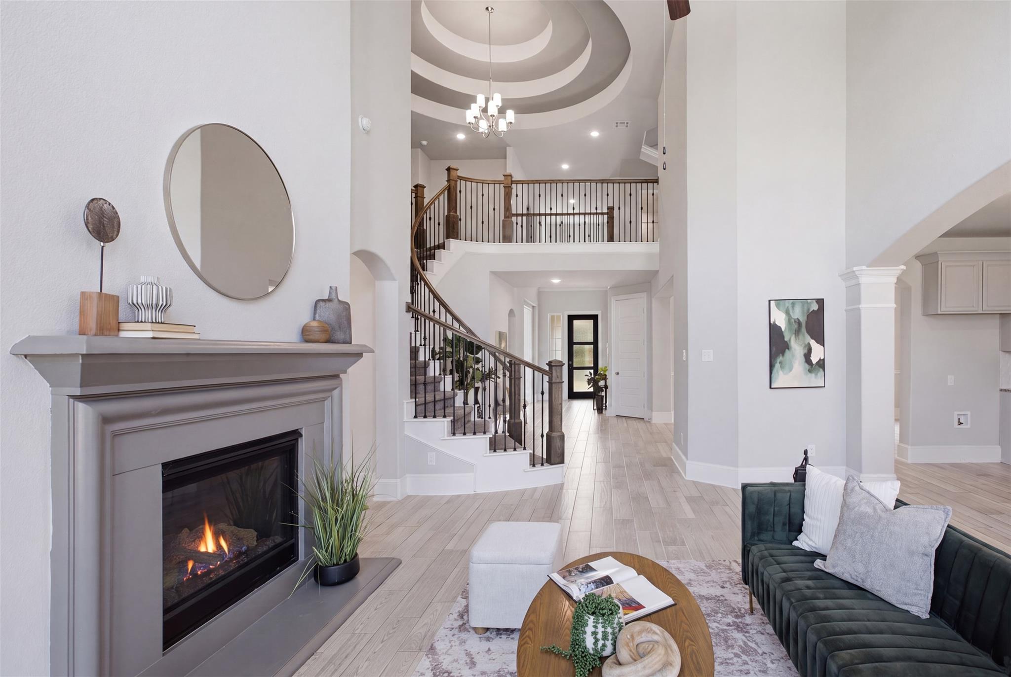 Grand two-story living area features a majestic f