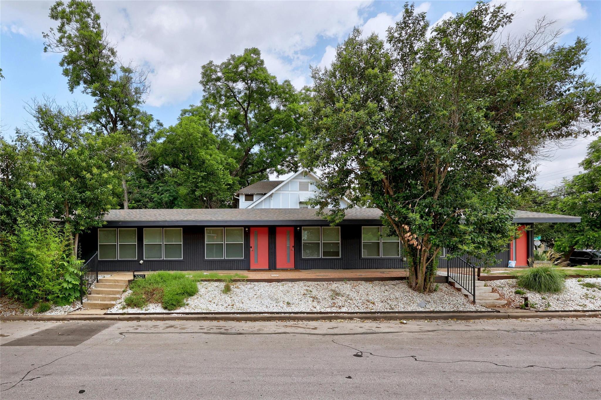 Distinctive exterior with striking red doors welc