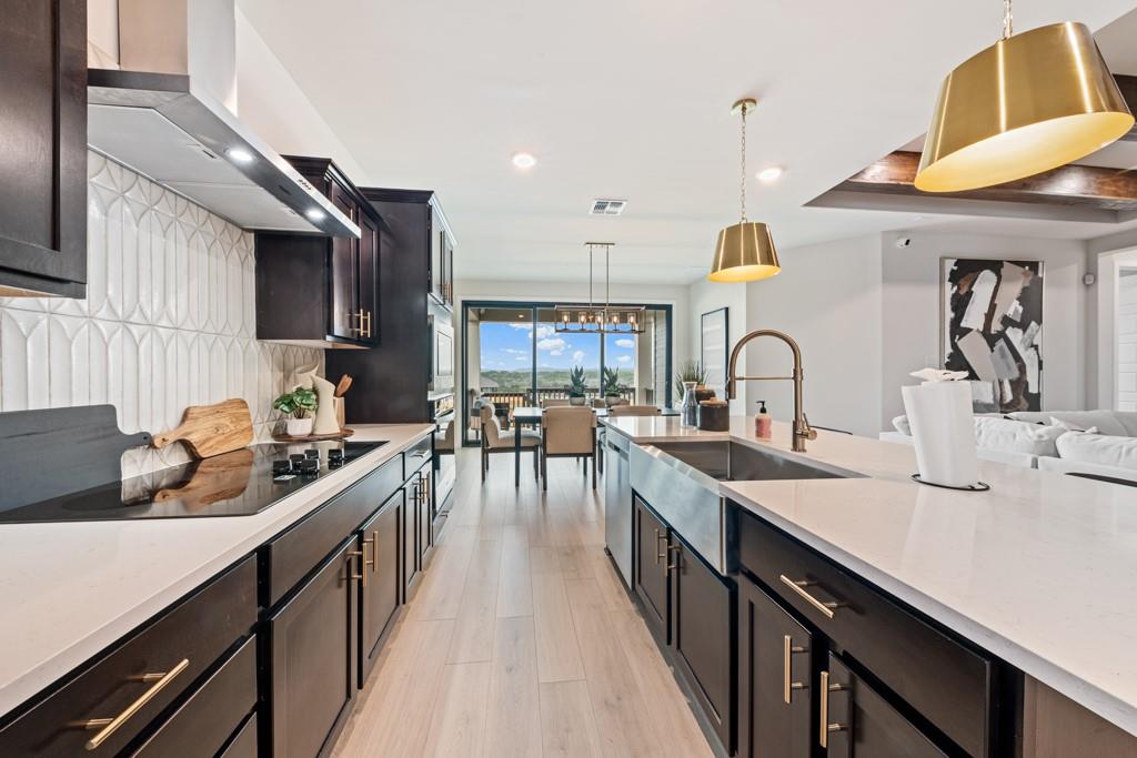 Rich dark cabinetry and polished stone countertop