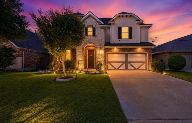 Stone and stucco exterior with inviting landscape