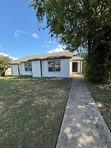 A well-maintained concrete path leads to this inv