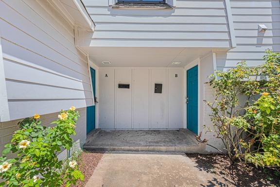 A welcoming front entrance features two bright bl