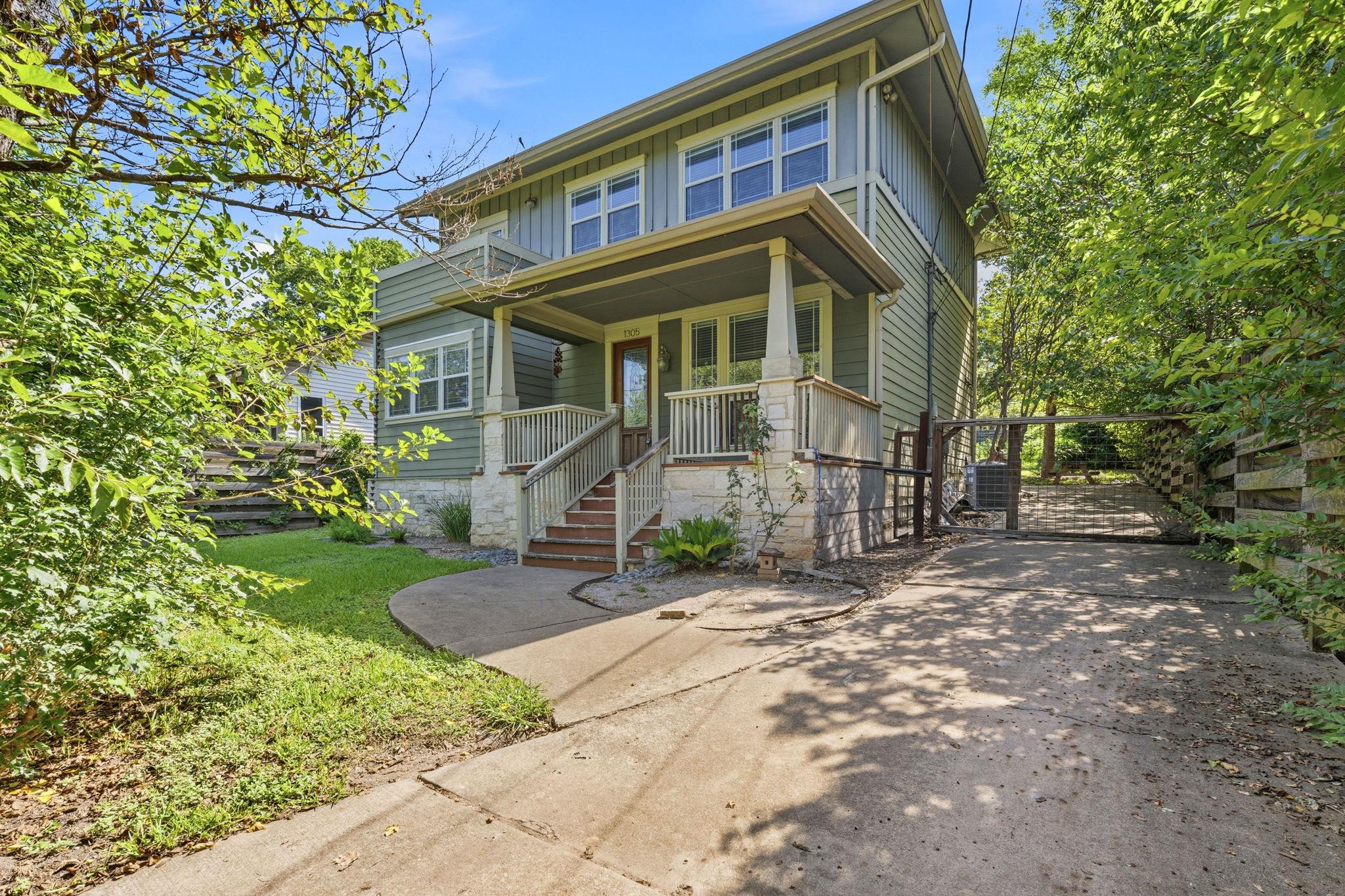 A welcoming front porch with classic railings fra