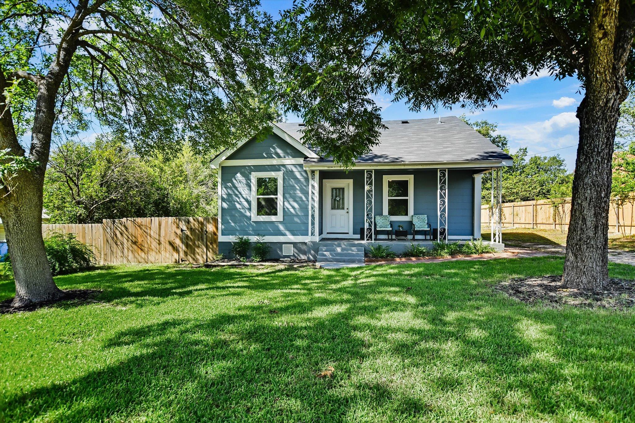 A charming blue residence with a welcoming front 