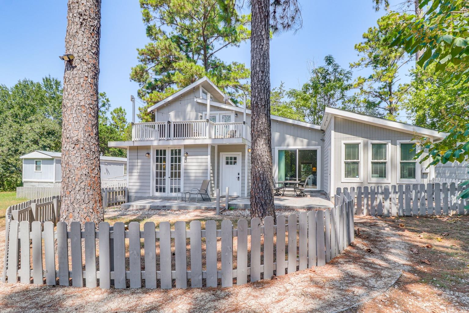 An inviting light gray residence features a welco