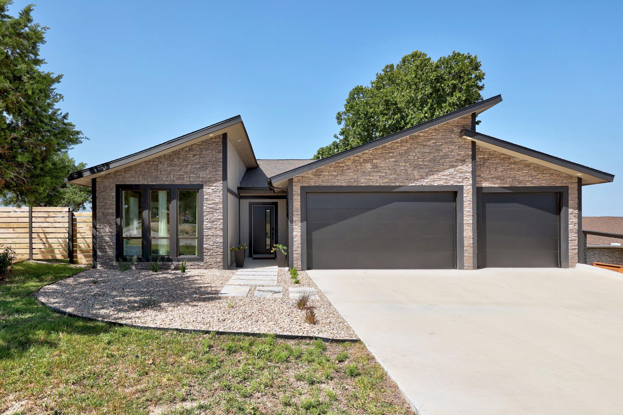 Modern stone-clad residence with an inviting entr