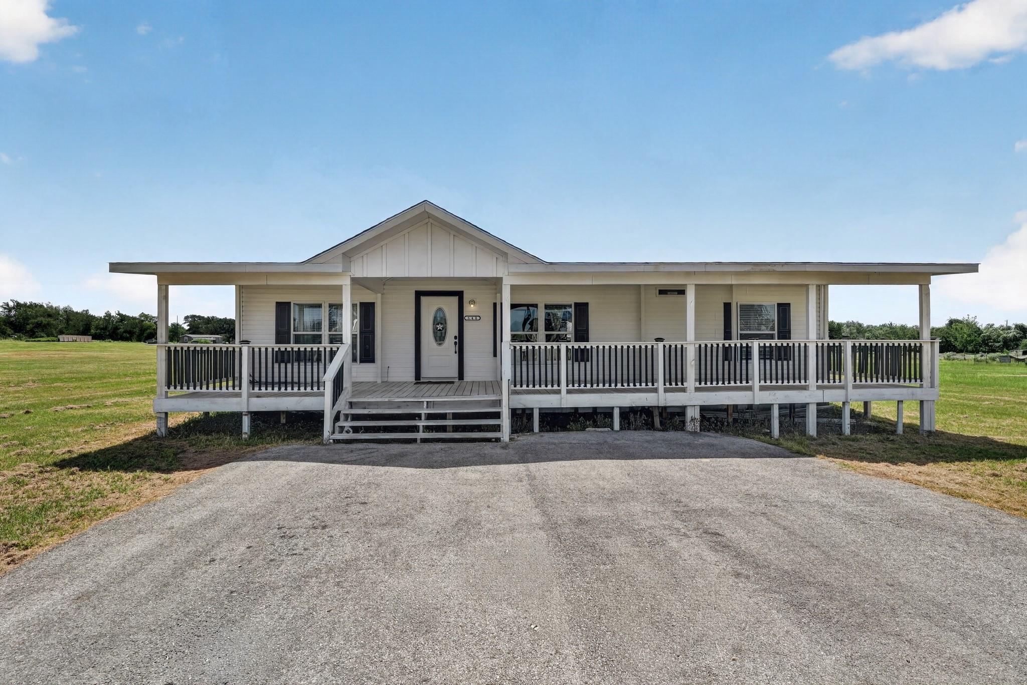 A welcoming front porch extends across this charm