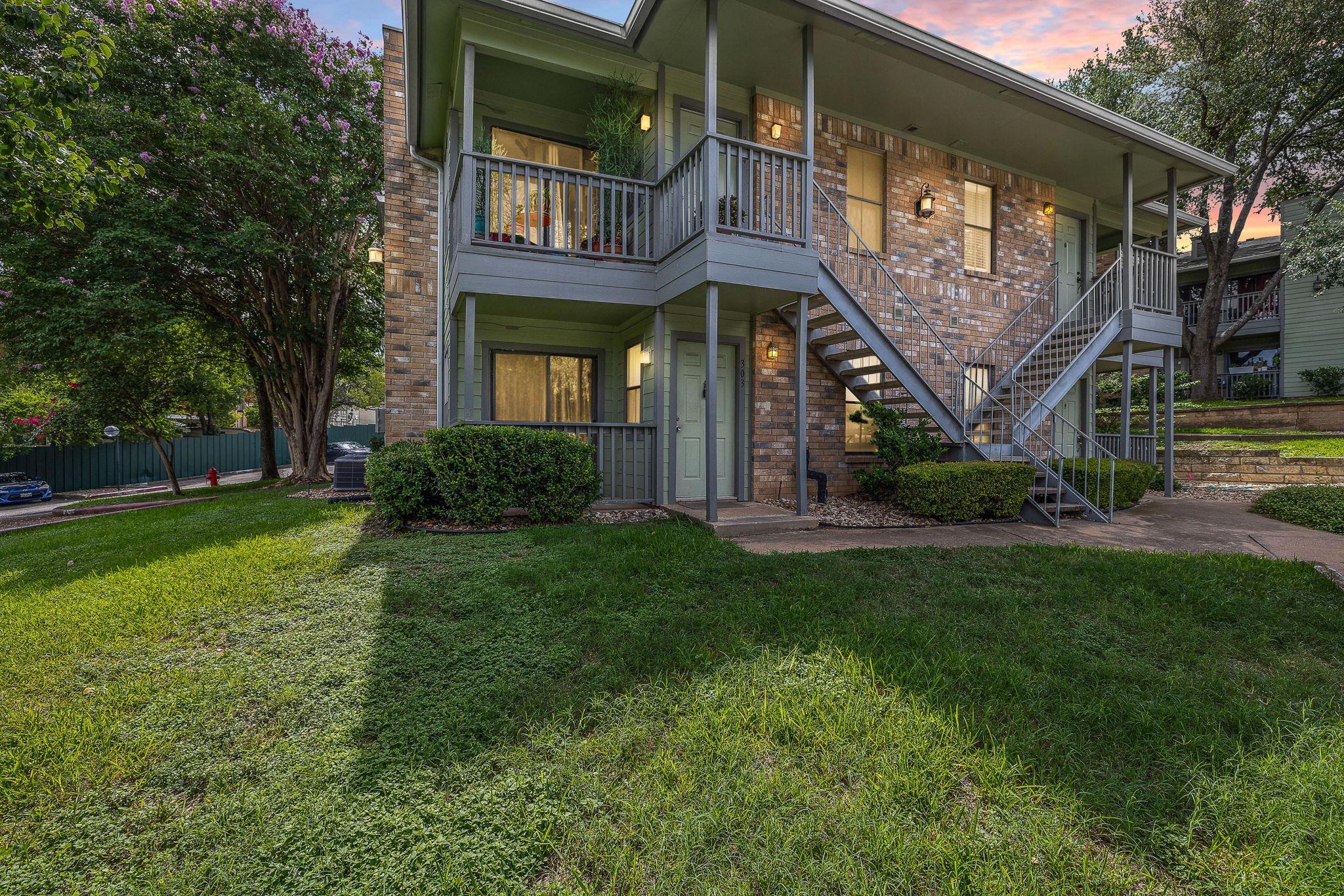 View of front of home with brick siding and stair