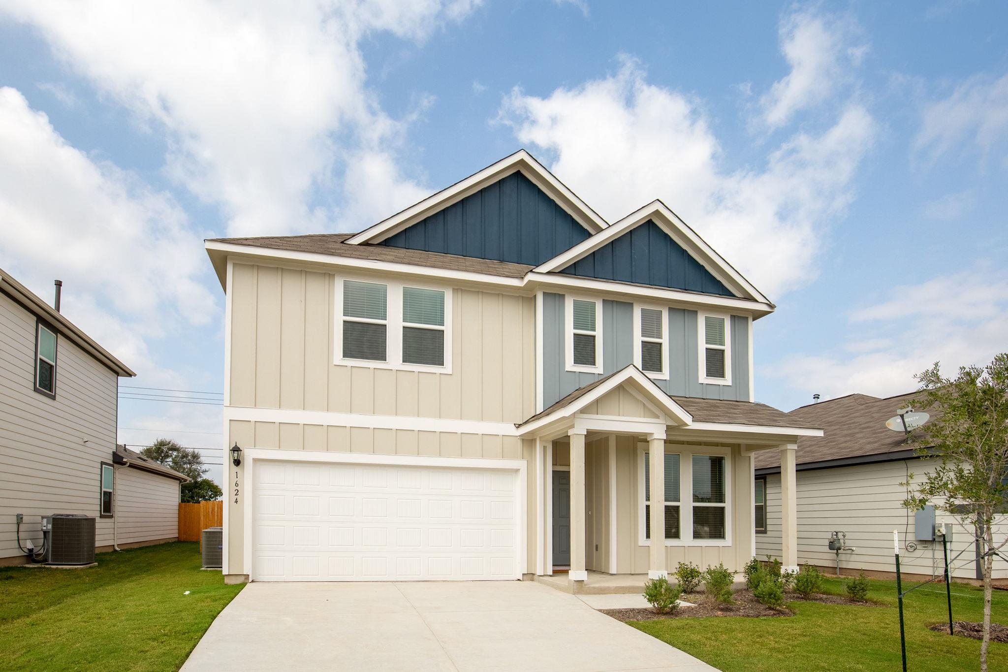 Board and batten siding meets a neat concrete dri