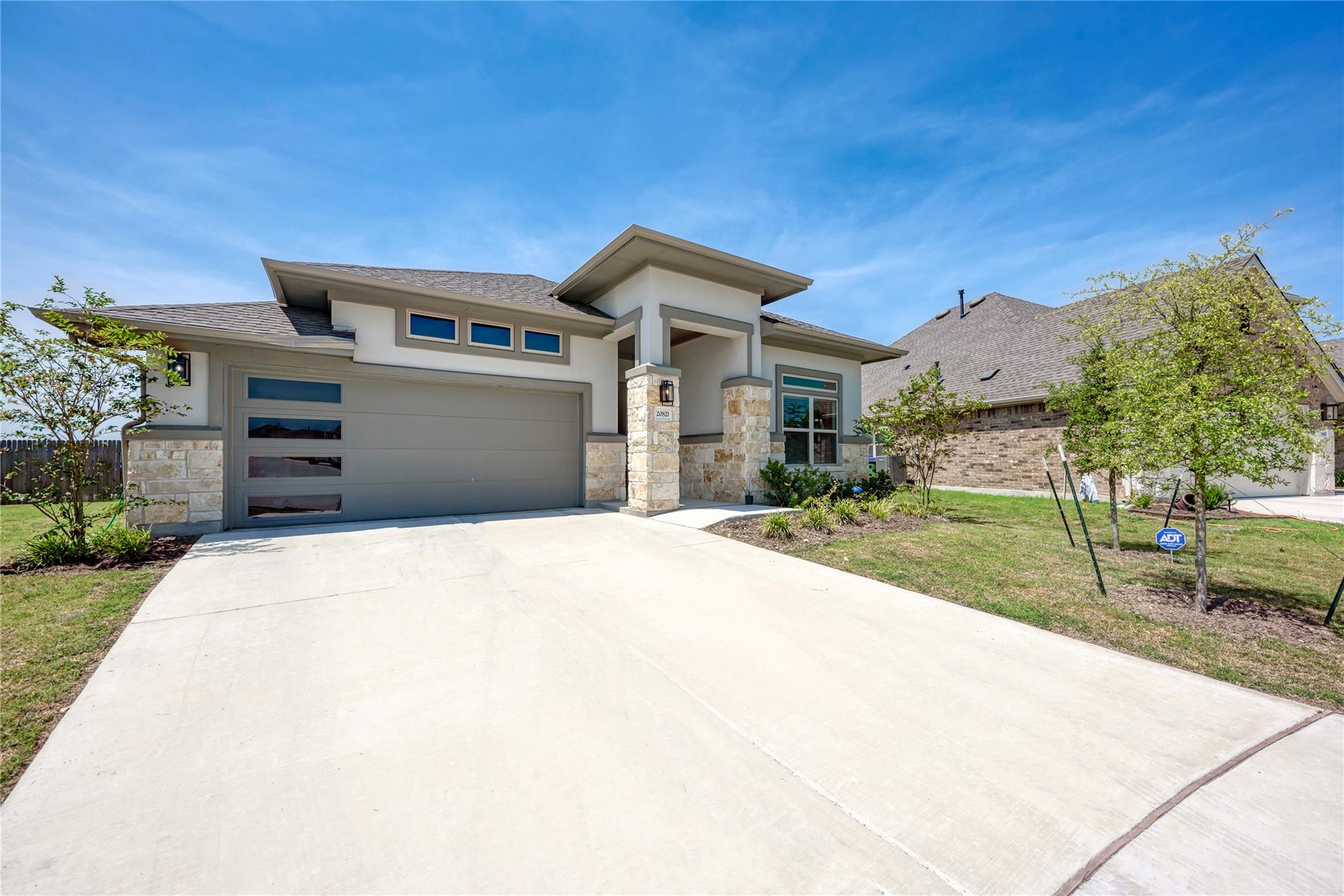 A contemporary facade showcases stone and stucco 