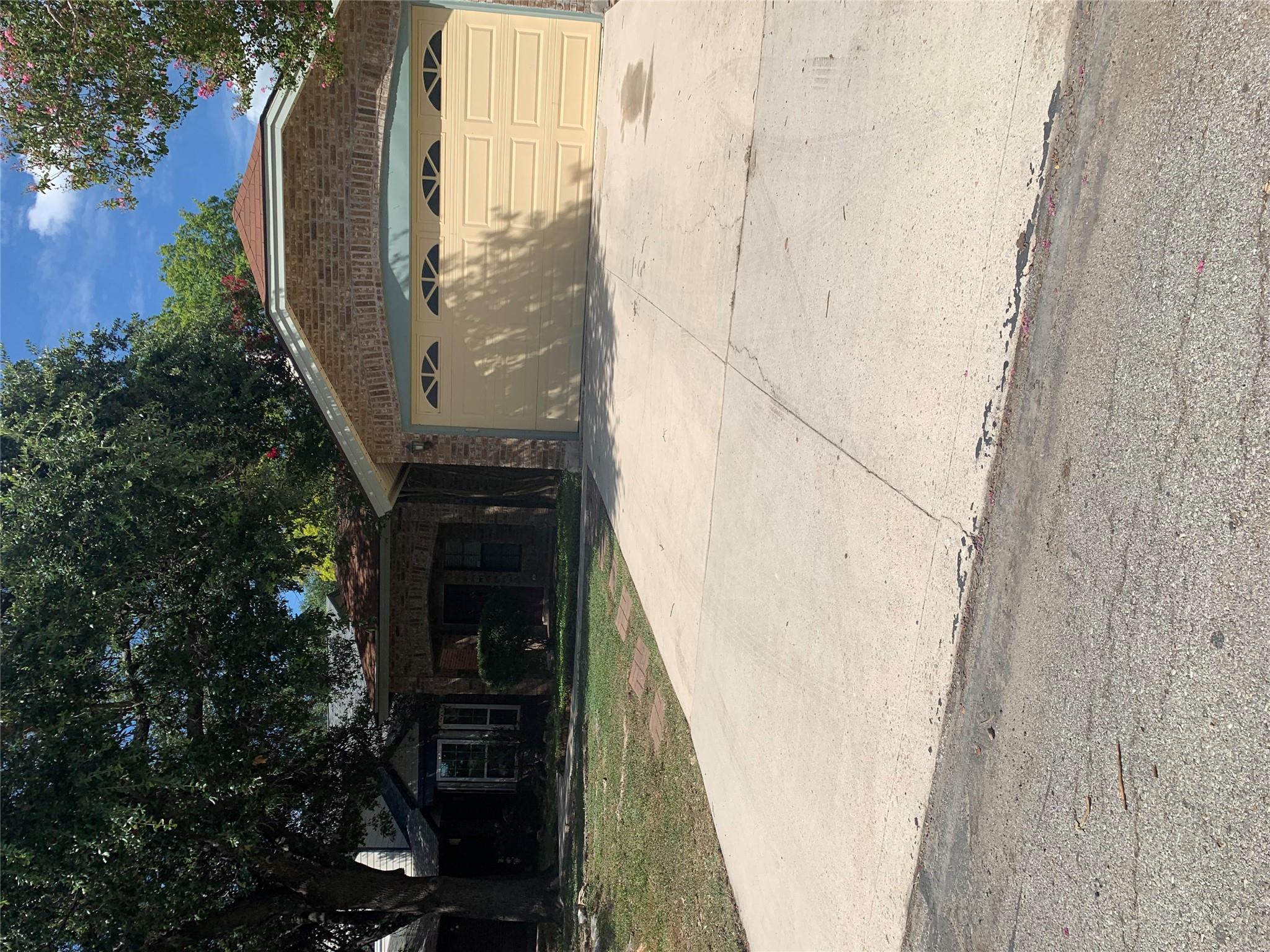 Ranch-style house featuring concrete driveway, an