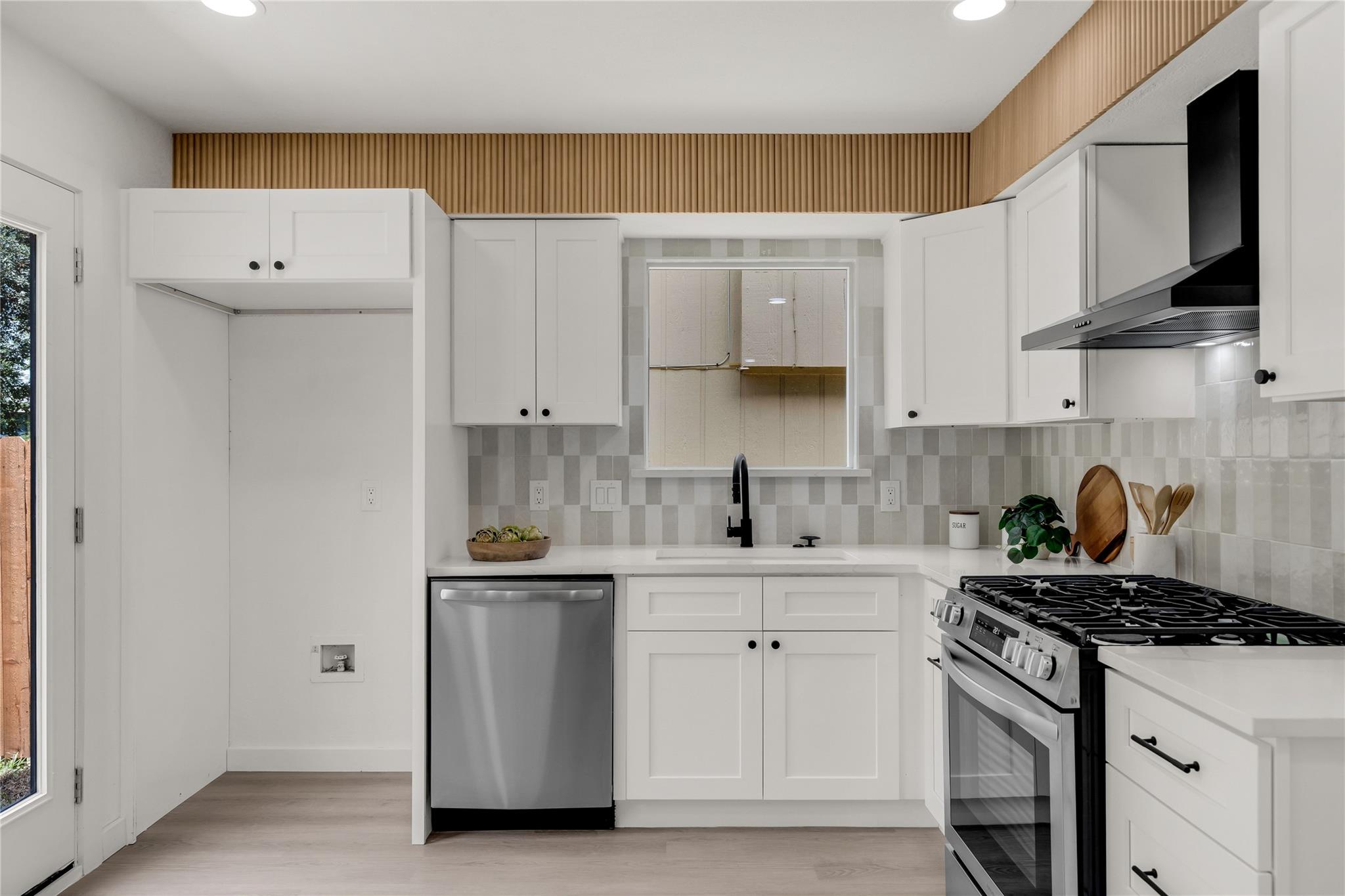 A well-lit kitchen with sleek appliances and ampl