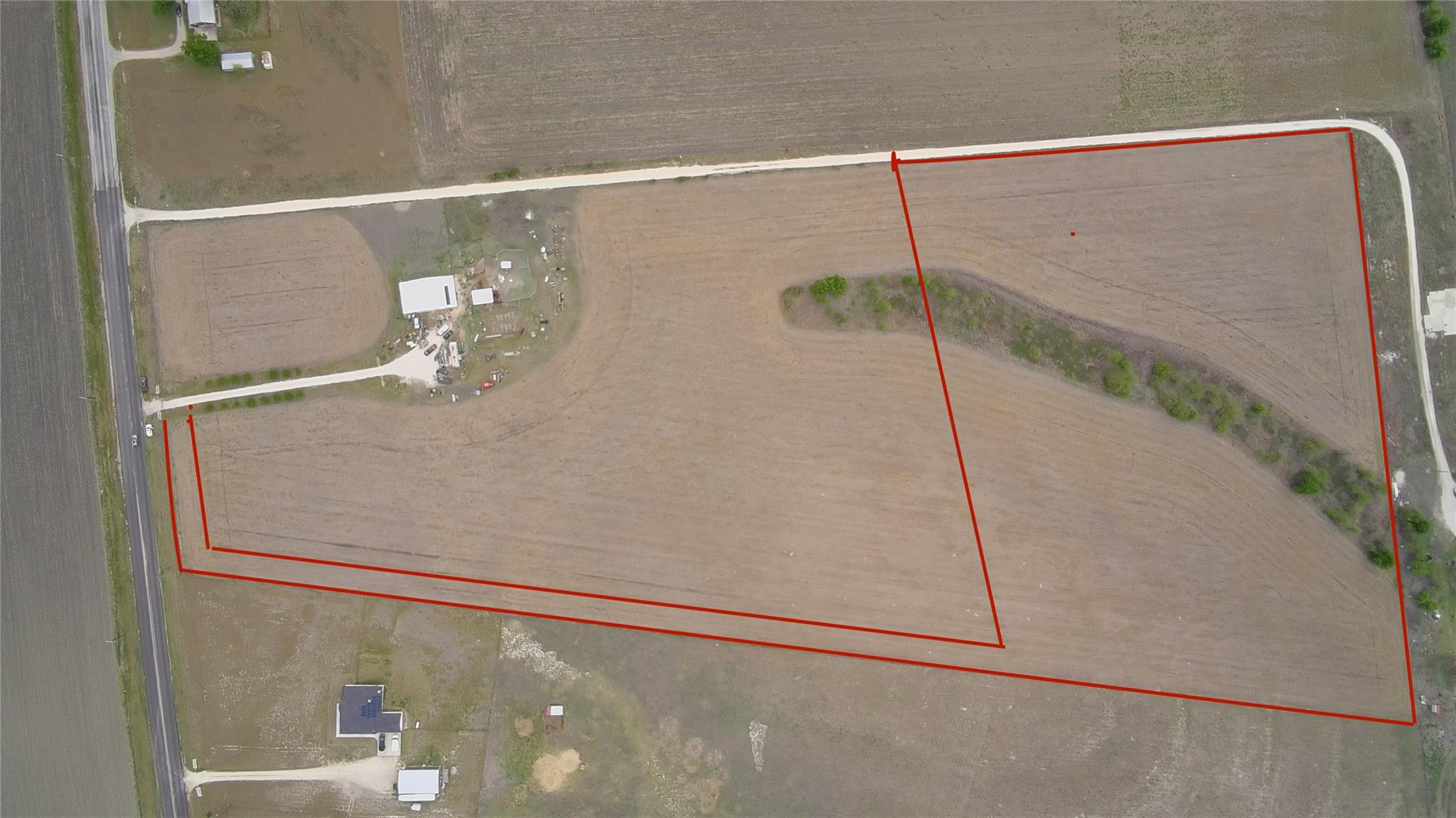 A vast, fertile land parcel bordered by roads, of