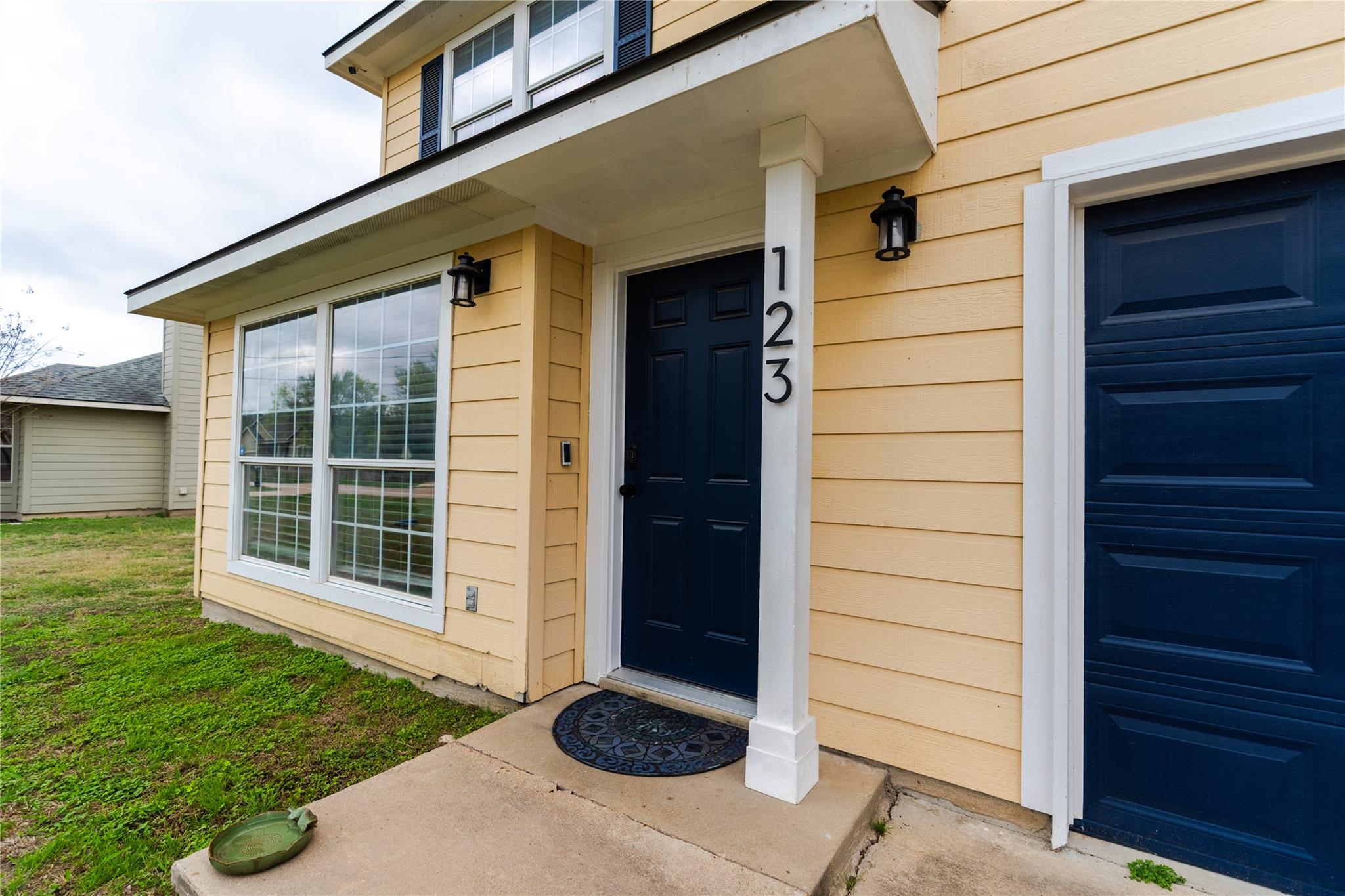 A welcoming entry featuring a dark-paneled door, 