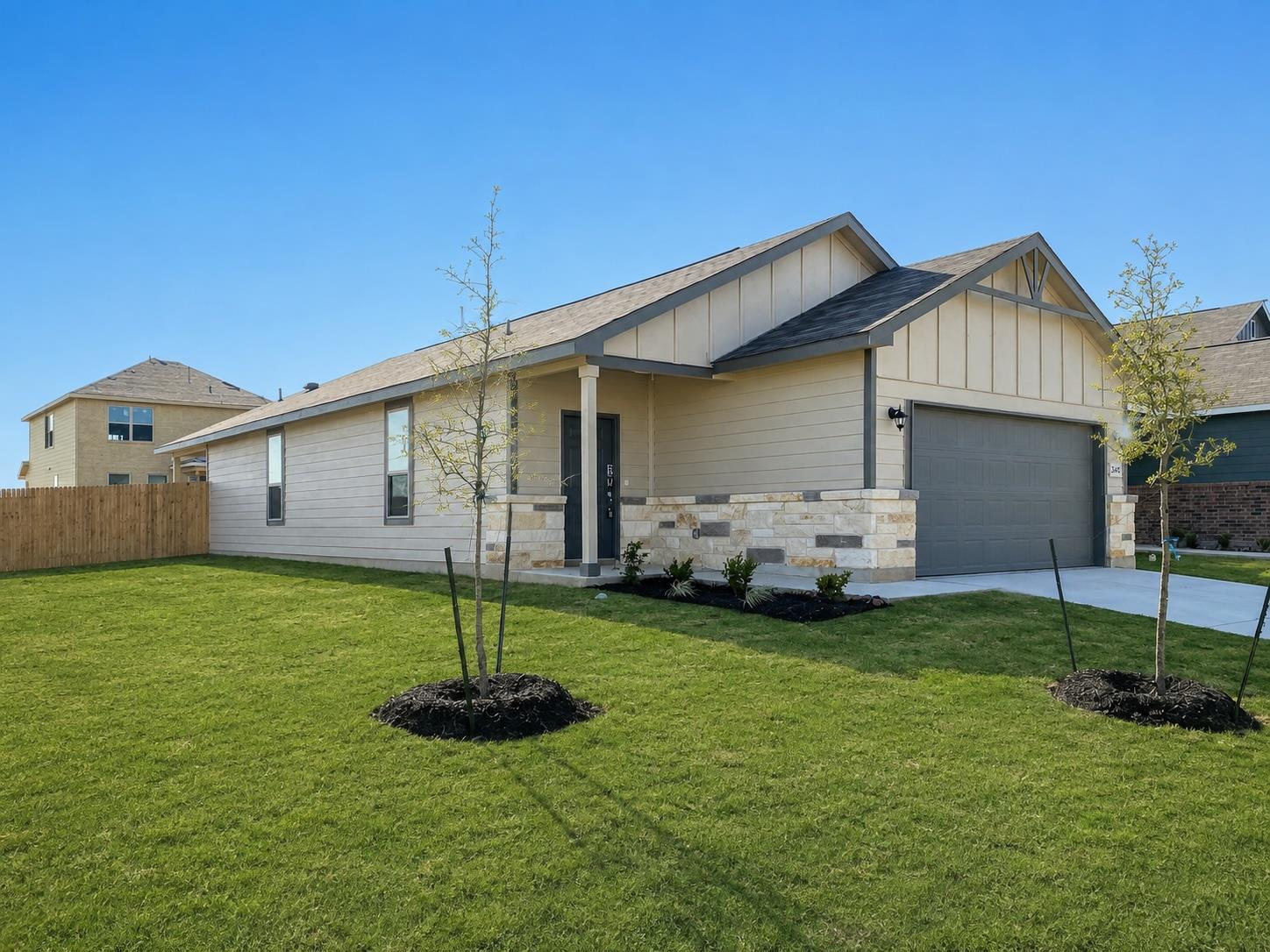 Attractive stone accents and a manicured green la