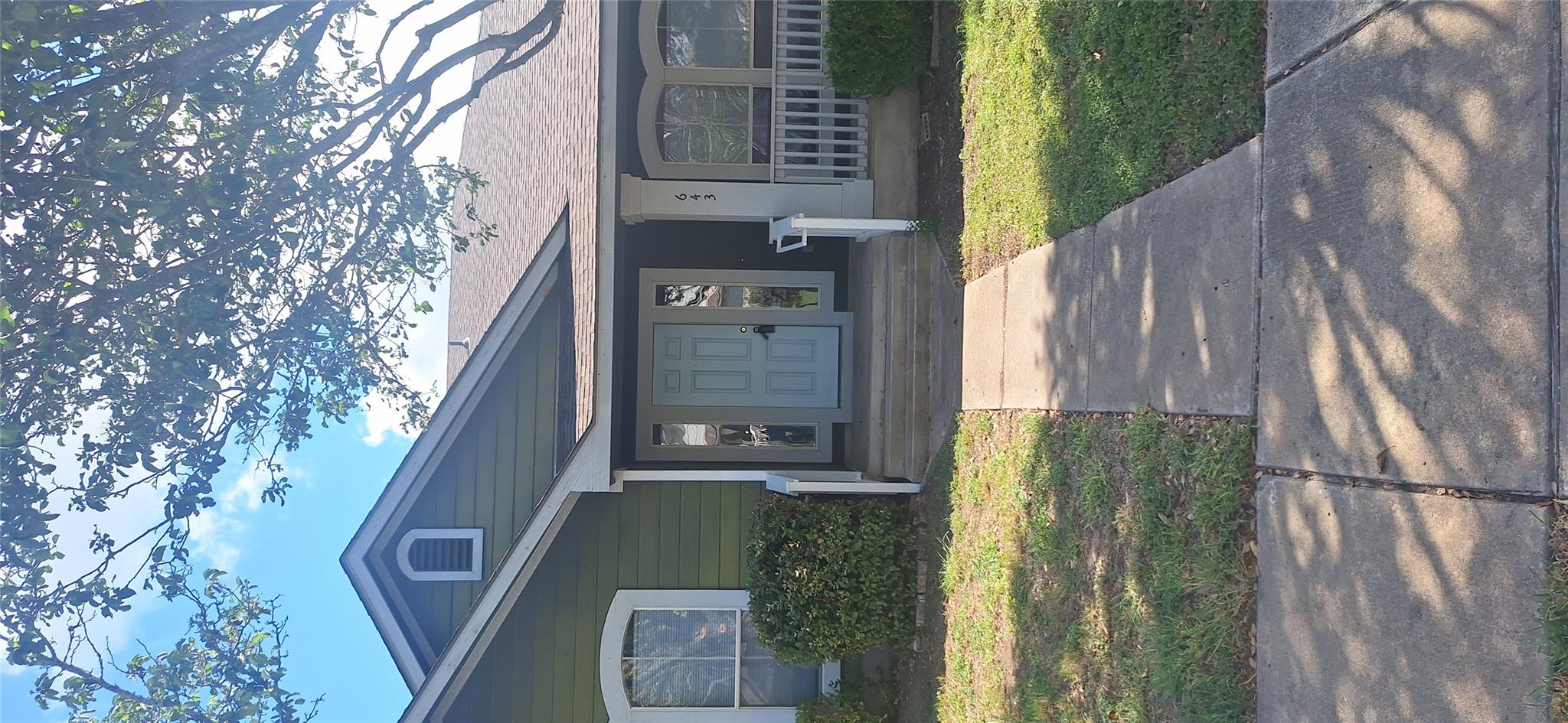 A welcoming olive-green home with an inviting lig