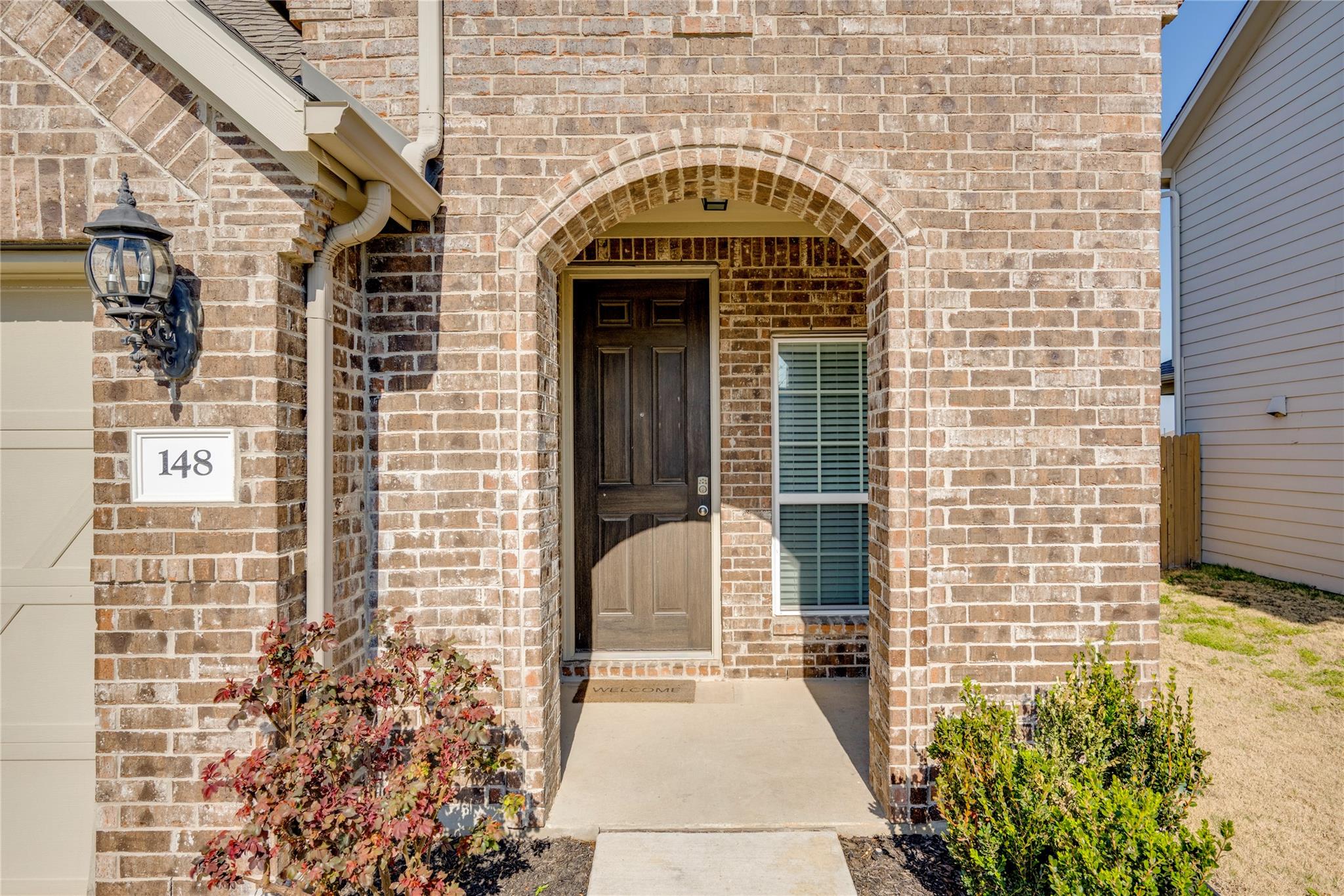A classic brick facade with an arched entryway we