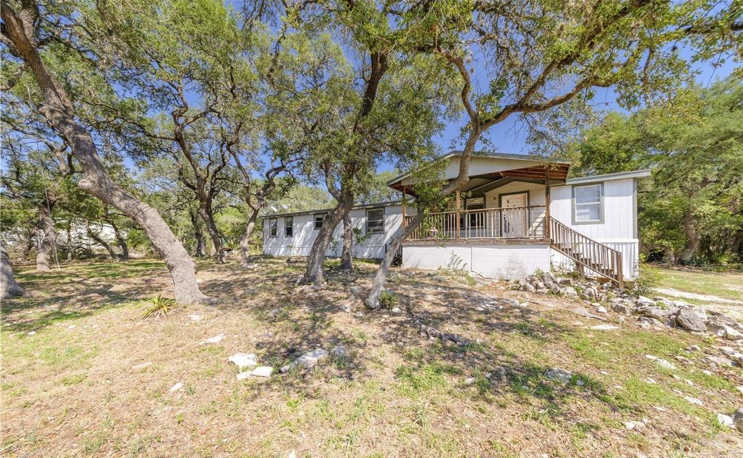 Mature trees provide a shaded retreat for this ho