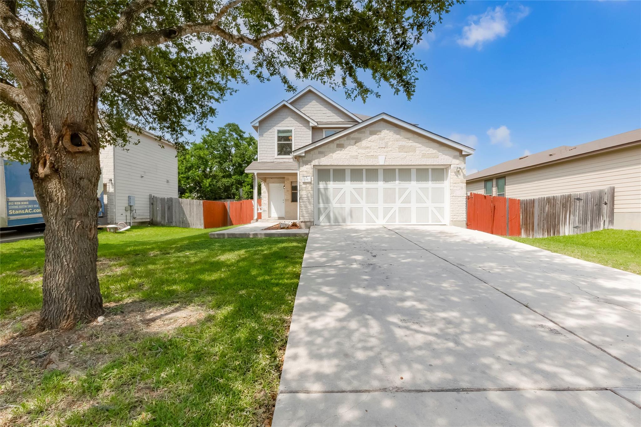 A well-maintained lawn and extended driveway lead
