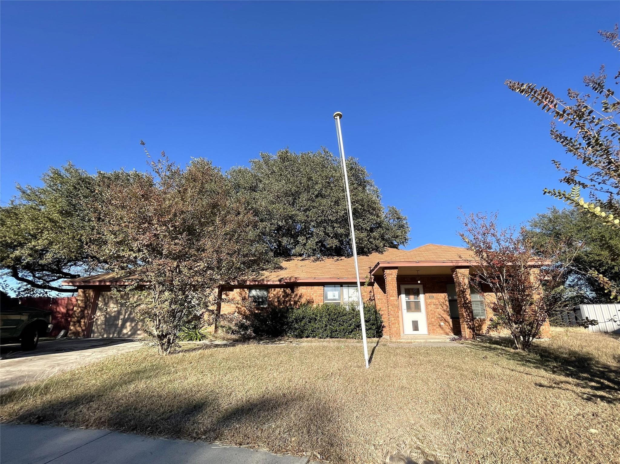 A well-maintained brick facade home with a front 