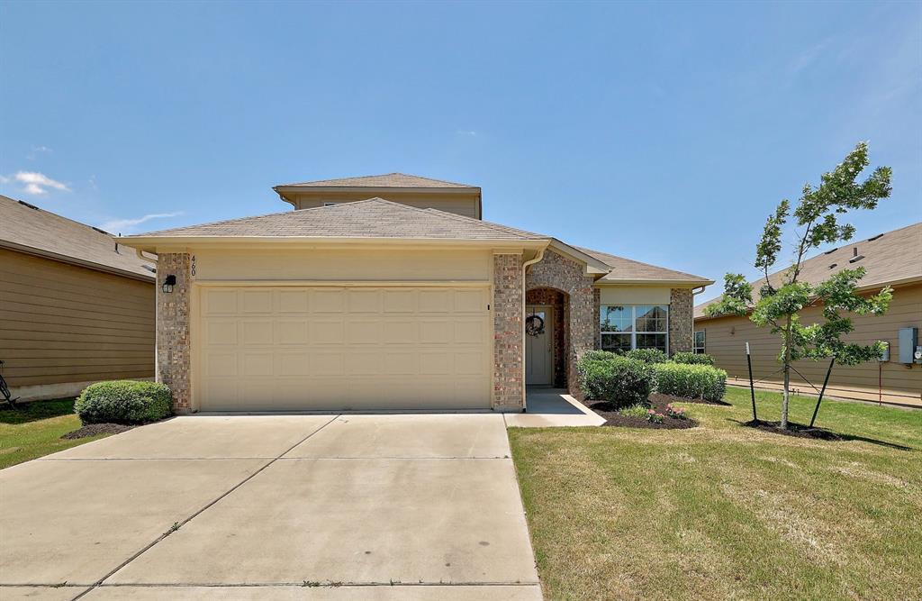A well-maintained facade with a two-car garage, b