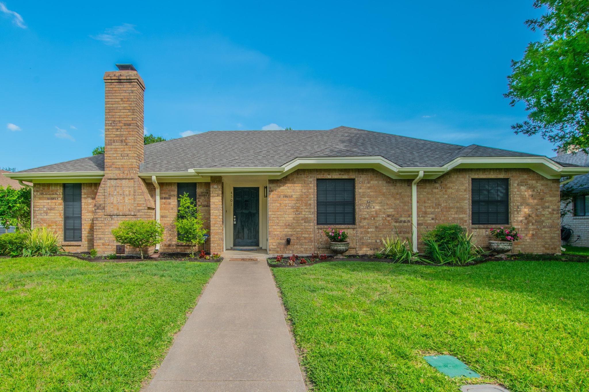 A classic brick exterior with a prominent chimney