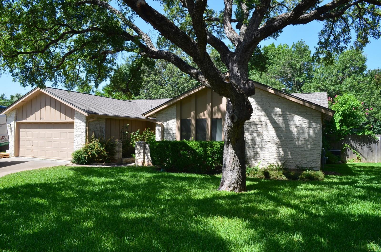 A classic ranch-style home features a spacious at