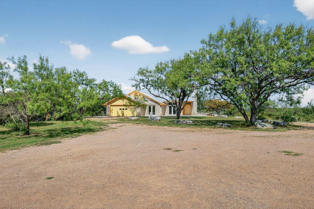 A striking stone and yellow-sided home awaits, ne
