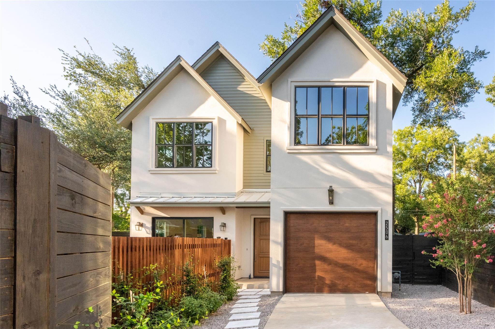 A modern facade with a striking wooden garage doo