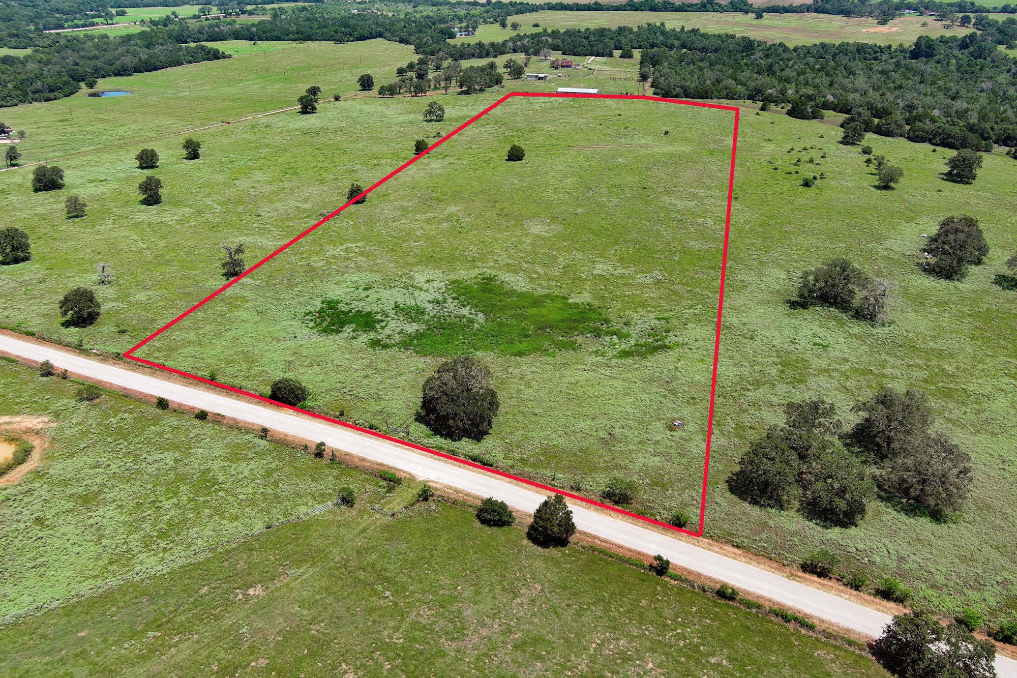 A spacious, verdant lot awaits your vision, borde
