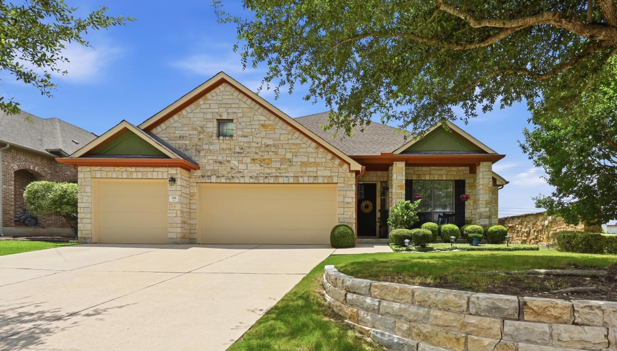 A well-maintained lawn and sturdy stone retaining