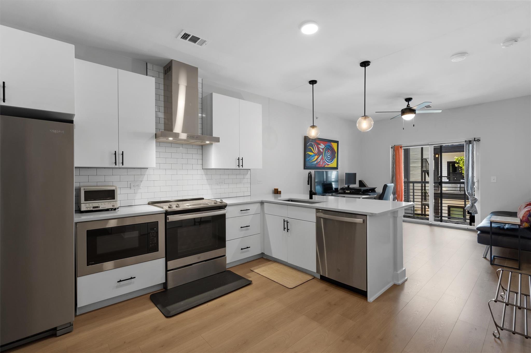 A contemporary kitchen and living area, complete 