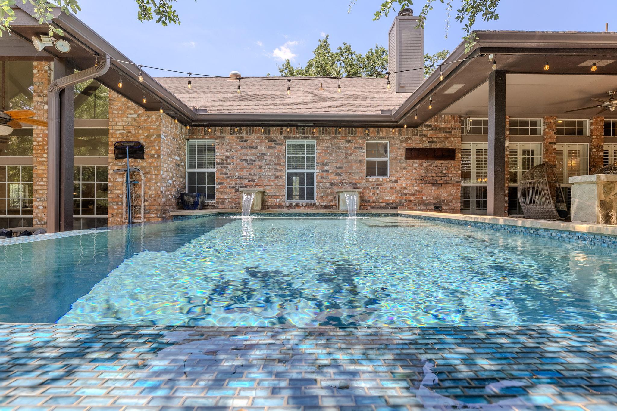 An inviting private pool and patio area await, of