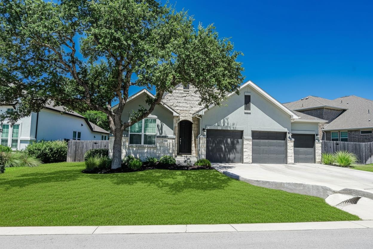 A well-maintained lawn and mature tree frame the 