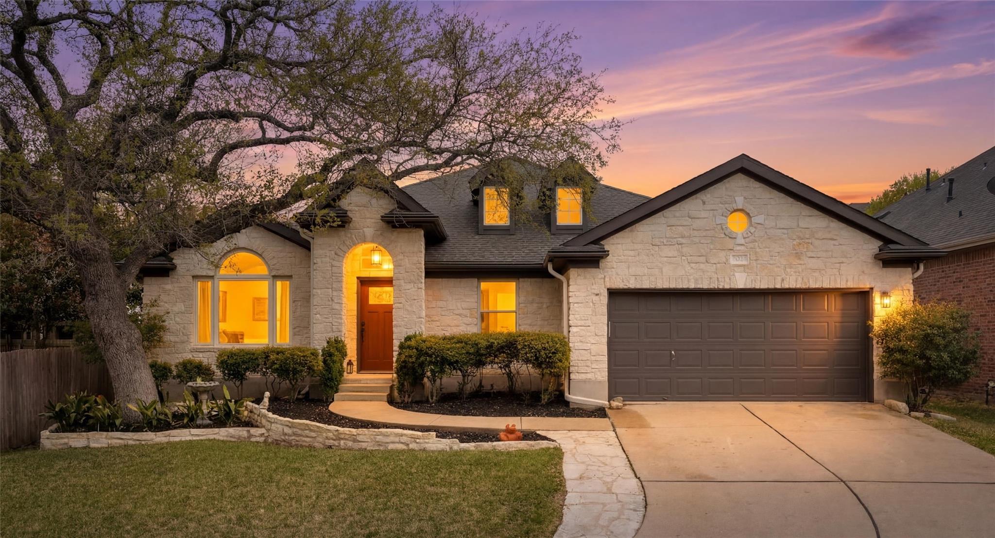 A graceful stone facade and mature landscaping we