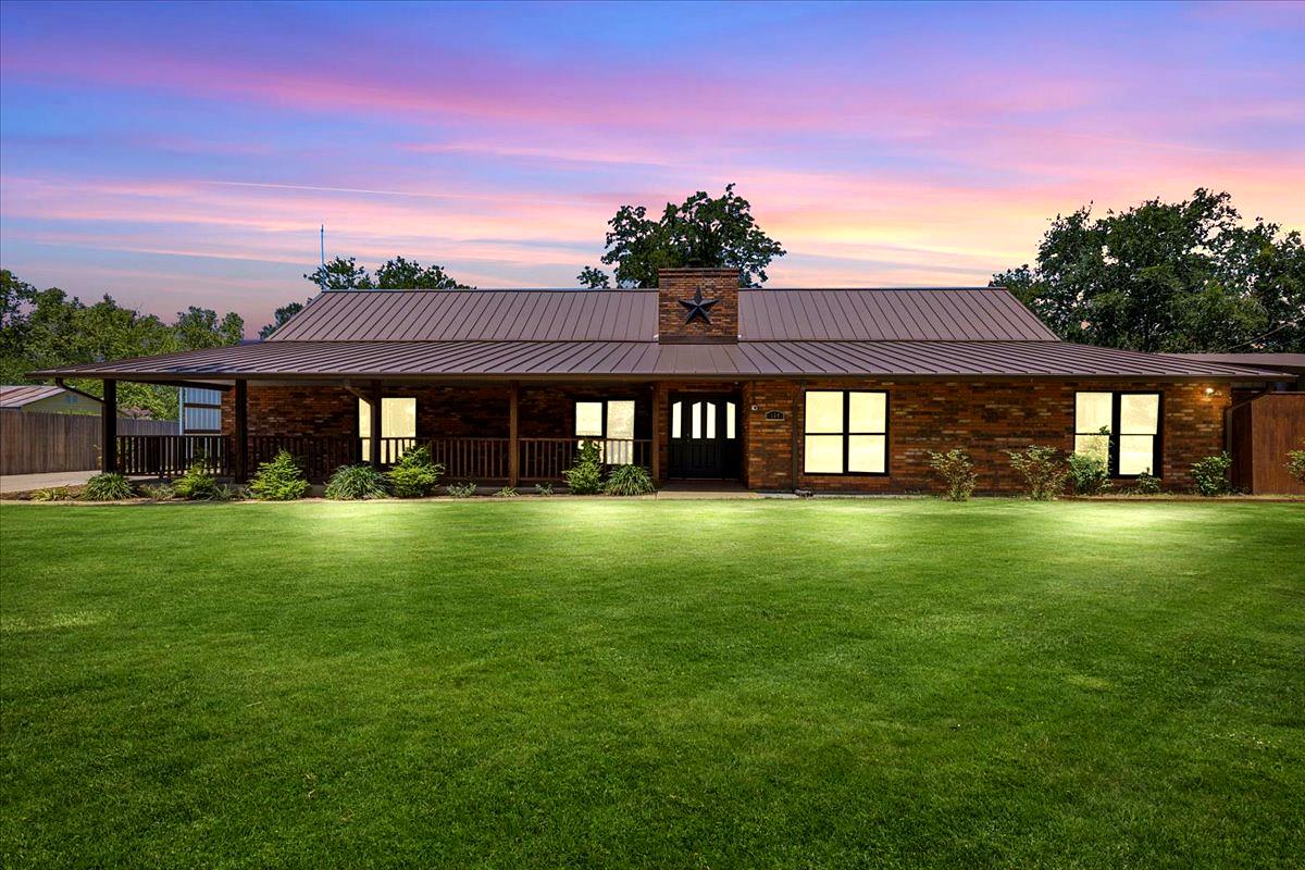 A classic brick ranch-style home presents a welco