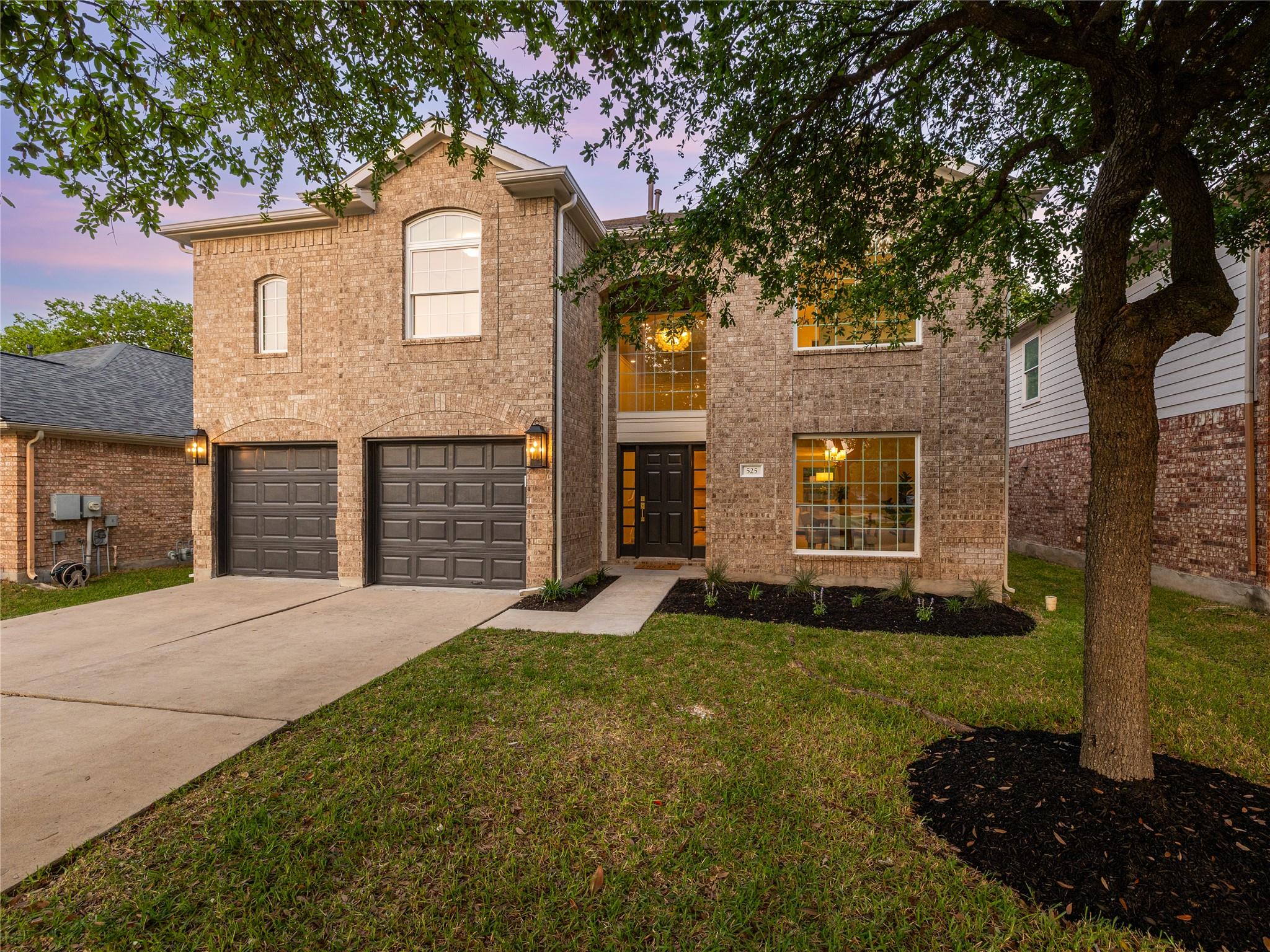 An inviting brick facade offers grand curb appeal