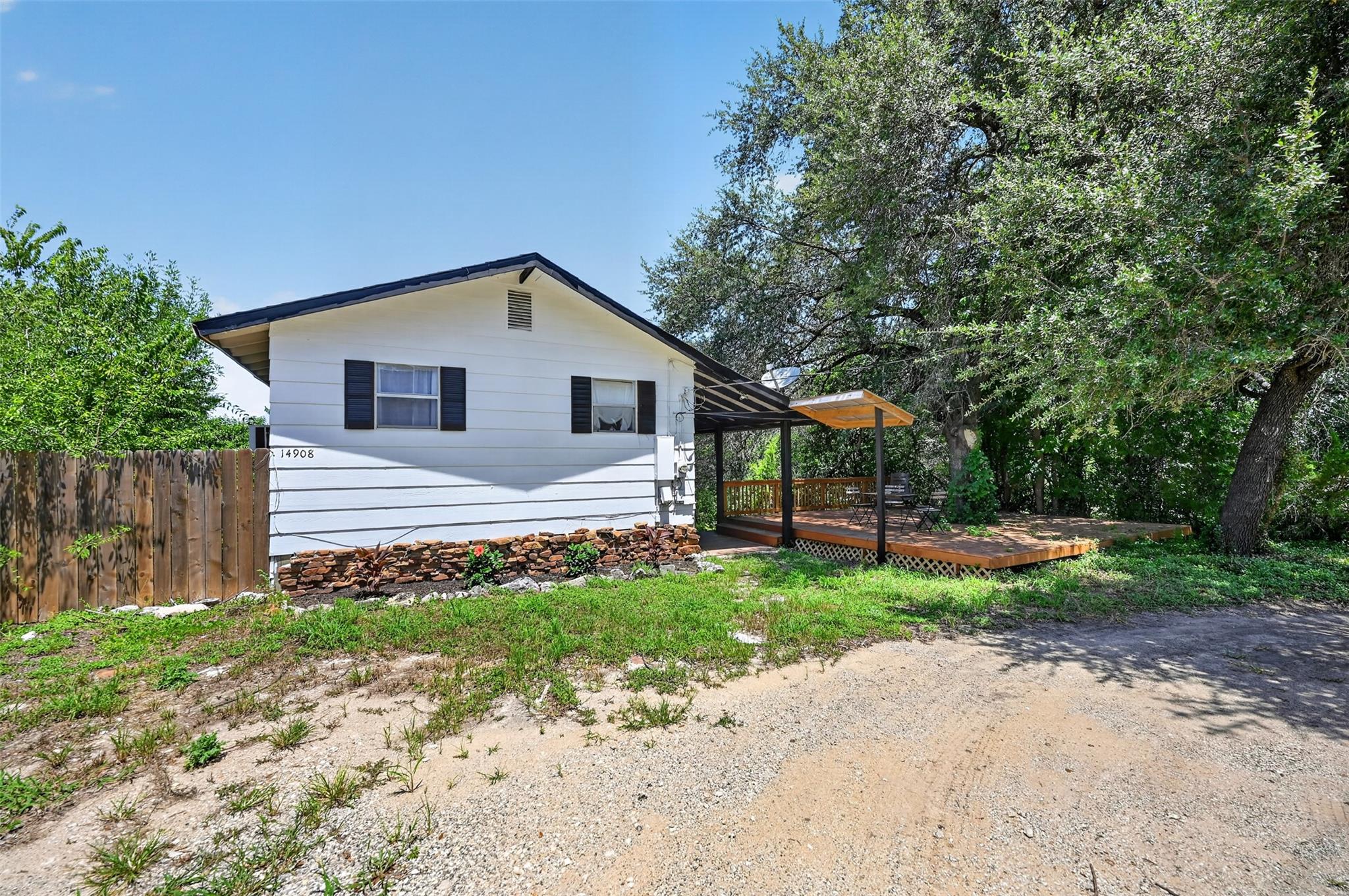 A quaint residence featuring a front deck with a 