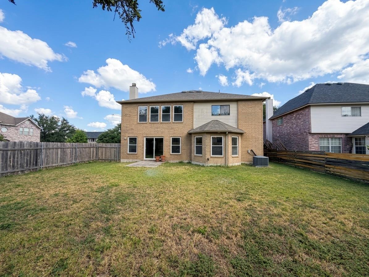 An inviting backyard space awaits, enclosed by a 