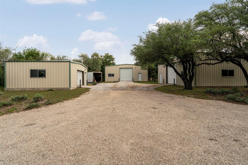 A spacious gravel driveway leads to multiple prac